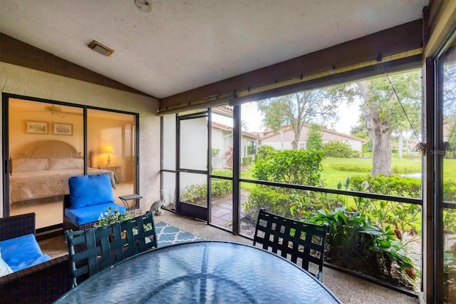 4001 Wilshire Cir E Unit 72, Sarasota, FL 34238 - sunroom featuring lofted ceiling, outdoor dining space, and healthy amount of natural light