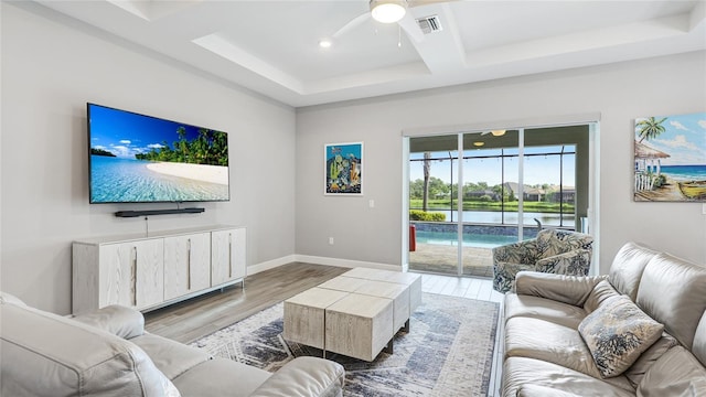 3431 Chestertown Loop, Bradenton, FL 34211 - living room featuring coffered ceiling, a ceiling fan, light wood-style floors, beamed ceiling, and recessed lighting