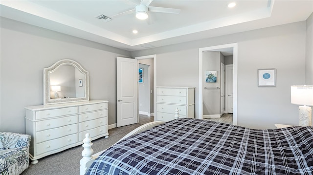 3431 Chestertown Loop, Bradenton, FL 34211 - bedroom with a tray ceiling, recessed lighting, light colored carpet, connected bathroom, and a ceiling fan