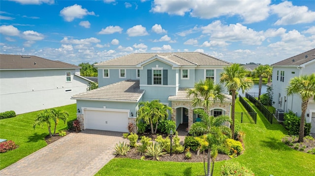 3431 Chestertown Loop, Bradenton, FL 34211 - mediterranean / spanish home featuring stone siding, a tile roof, decorative driveway, a garage, and stucco siding
