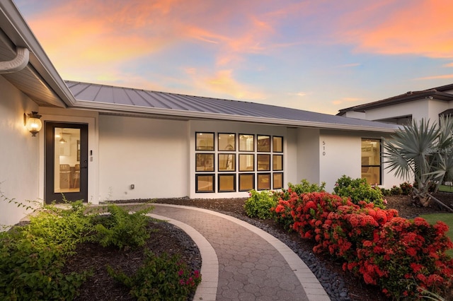 510 Putter Ln, Longboat Key, FL 34228 - doorway to property with stucco siding, a metal roof, and a standing seam roof