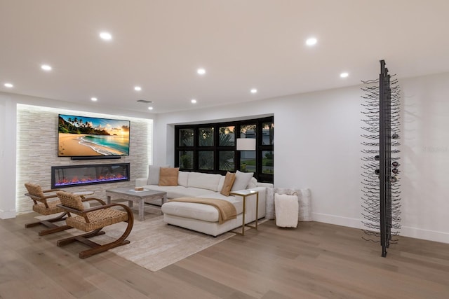 510 Putter Ln, Longboat Key, FL 34228 - living room featuring wood finished floors, a glass covered fireplace, and recessed lighting