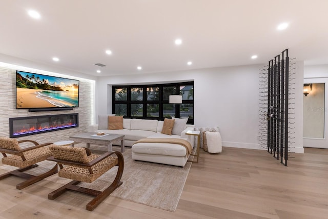 510 Putter Ln, Longboat Key, FL 34228 - living room with wood finished floors, a glass covered fireplace, and recessed lighting