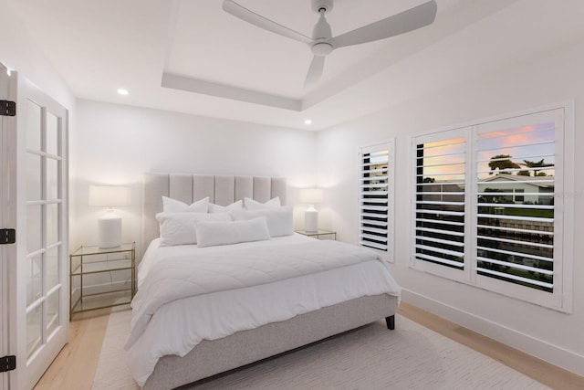 510 Putter Ln, Longboat Key, FL 34228 - bedroom featuring wood finished floors, recessed lighting, a tray ceiling, and ceiling fan