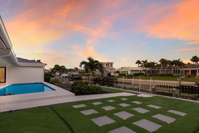 510 Putter Ln, Longboat Key, FL 34228 - pool at dusk featuring a yard and a residential view