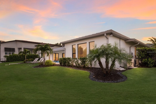 510 Putter Ln, Longboat Key, FL 34228 - view of front of home featuring stucco siding and a yard