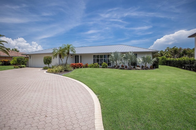 510 Putter Ln, Longboat Key, FL 34228 - view of front facade featuring an attached garage, decorative driveway, and a metal roof