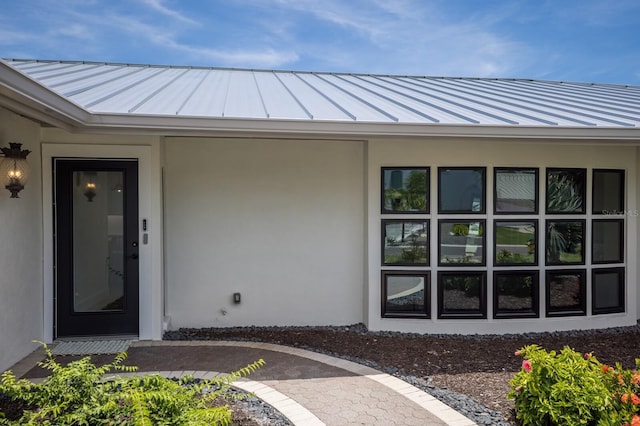 510 Putter Ln, Longboat Key, FL 34228 - doorway to property featuring a metal roof, a standing seam roof, and stucco siding
