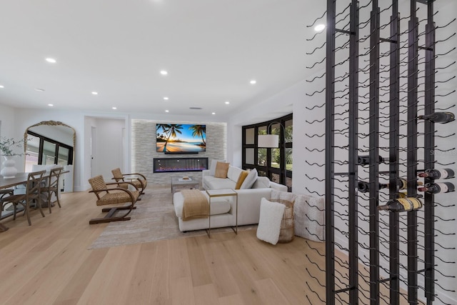 510 Putter Ln, Longboat Key, FL 34228 - living area with a glass covered fireplace, wood finished floors, and recessed lighting