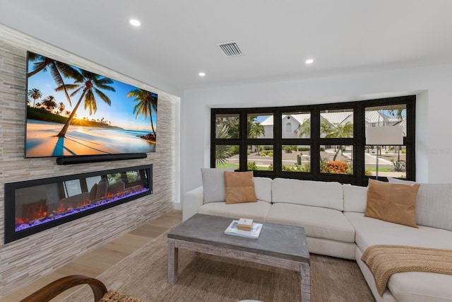 510 Putter Ln, Longboat Key, FL 34228 - living area with wood finished floors, a glass covered fireplace, and recessed lighting