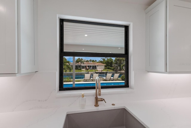 510 Putter Ln, Longboat Key, FL 34228 - kitchen view of white cabinets and light stone counters