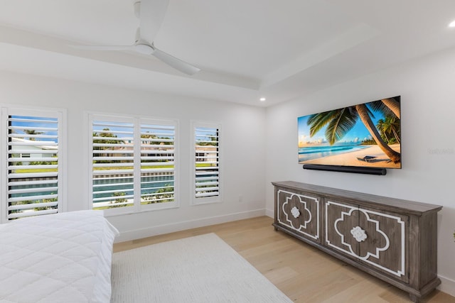 510 Putter Ln, Longboat Key, FL 34228 - bedroom with light wood-style floors, recessed lighting, ceiling fan, and a tray ceiling