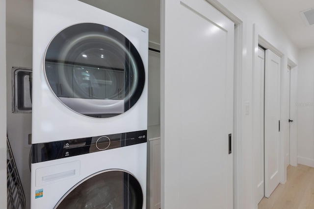 510 Putter Ln, Longboat Key, FL 34228 - laundry room featuring stacked washer / dryer and light wood finished floors