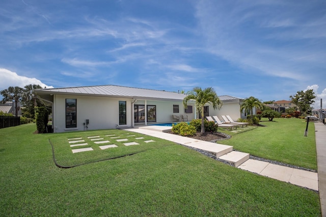 510 Putter Ln, Longboat Key, FL 34228 - rear view of house featuring a lawn, a metal roof, and a patio area