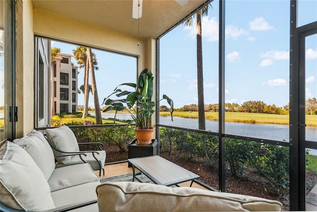 7121 River Hammock Dr Unit 102, Bradenton, FL 34212 - sunroom / solarium with a water view, outdoor lounge area, ceiling fan, and plenty of natural light