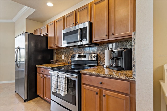 7121 River Hammock Dr Unit 102, Bradenton, FL 34212 - kitchen featuring appliances with stainless steel finishes, crown molding, decorative backsplash, dark stone countertops, and brown cabinetry