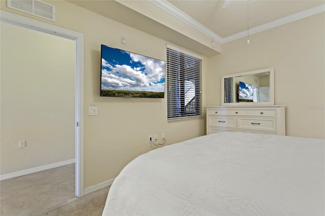 7121 River Hammock Dr Unit 102, Bradenton, FL 34212 - bedroom featuring ornamental molding, a ceiling fan, light tile patterned floors, and light carpet