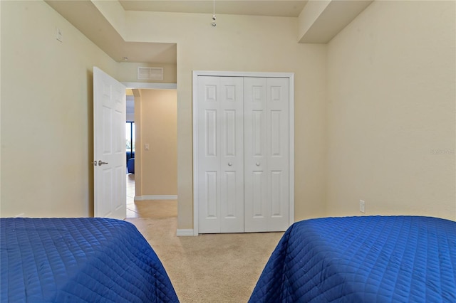 7121 River Hammock Dr Unit 102, Bradenton, FL 34212 - bedroom with light colored carpet and a closet