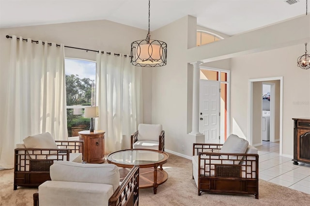 7960 Hampton Ct, University Park, FL 34201 - living area featuring washer / clothes dryer, lofted ceiling, light colored carpet, decorative columns, and light tile patterned flooring