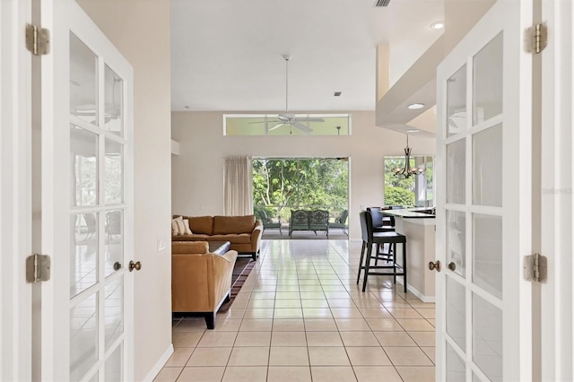 7960 Hampton Ct, University Park, FL 34201 - living room with ceiling fan, light tile patterned floors, a chandelier, and french doors