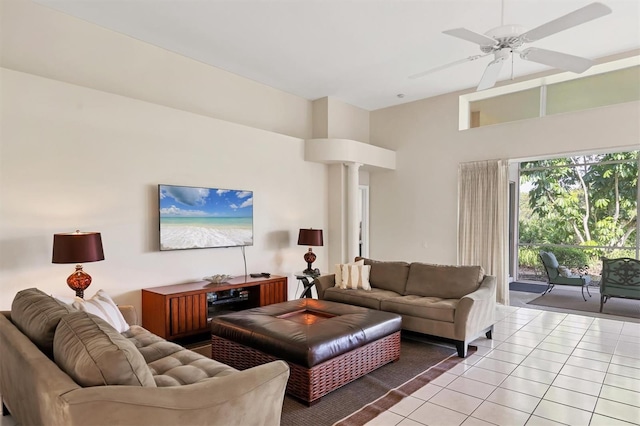 7960 Hampton Ct, University Park, FL 34201 - living area with light tile patterned floors, a towering ceiling, ceiling fan, and ornate columns