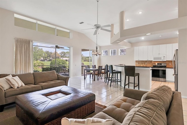 7960 Hampton Ct, University Park, FL 34201 - living room featuring ceiling fan, light tile patterned flooring, high vaulted ceiling, a chandelier, and recessed lighting