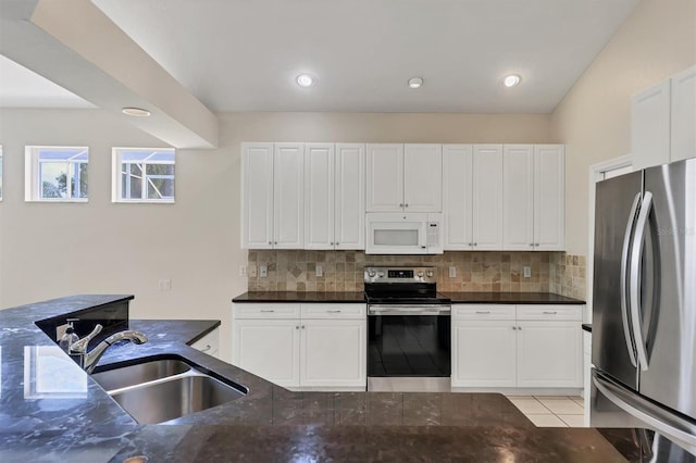 7960 Hampton Ct, University Park, FL 34201 - kitchen featuring stainless steel appliances, decorative backsplash, dark stone countertops, and white cabinets