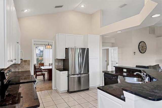 7960 Hampton Ct, University Park, FL 34201 - kitchen with stainless steel appliances, light tile patterned floors, high vaulted ceiling, white cabinets, and backsplash