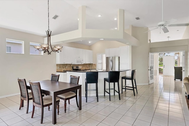 7960 Hampton Ct, University Park, FL 34201 - dining space featuring ceiling fan, light tile patterned floors, recessed lighting, a chandelier, and high vaulted ceiling