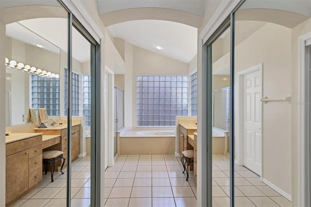 7960 Hampton Ct, University Park, FL 34201 - full bath featuring vanity, a bath, tile patterned floors, lofted ceiling, and a shower stall