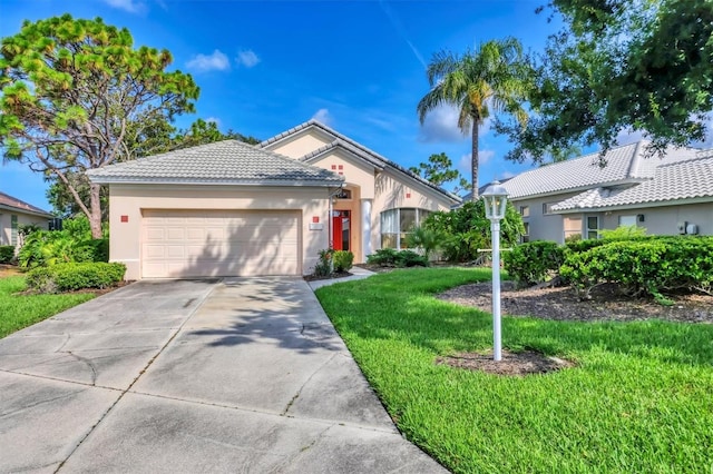 7960 Hampton Ct, University Park, FL 34201 - single story home with an attached garage, a front lawn, stucco siding, driveway, and a tiled roof