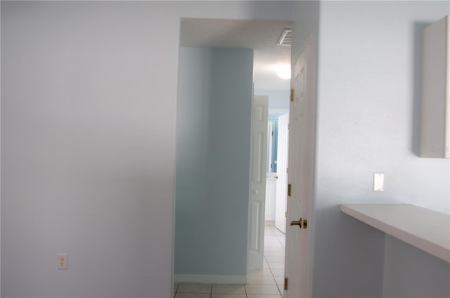 671 E Baffin Dr, Venice, FL 34293 - hall featuring light tile patterned flooring and baseboards
