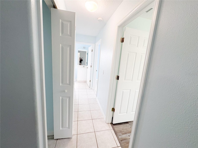 671 E Baffin Dr, Venice, FL 34293 - hallway with light tile patterned flooring and a textured wall