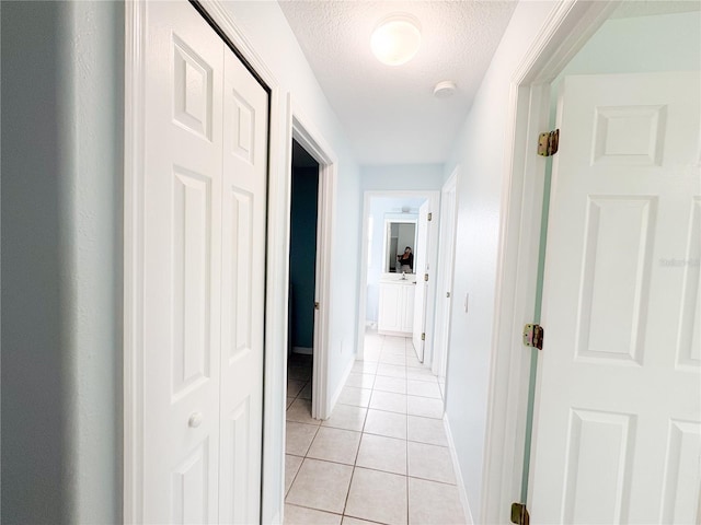 671 E Baffin Dr, Venice, FL 34293 - hallway featuring light tile patterned flooring and a textured ceiling