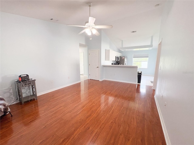 671 E Baffin Dr, Venice, FL 34293 - unfurnished living room with wood finished floors and a ceiling fan