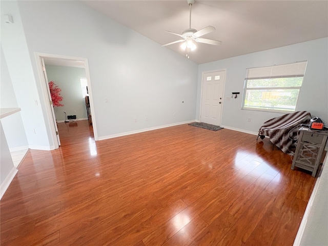 671 E Baffin Dr, Venice, FL 34293 - unfurnished living room featuring lofted ceiling, a ceiling fan, and wood finished floors