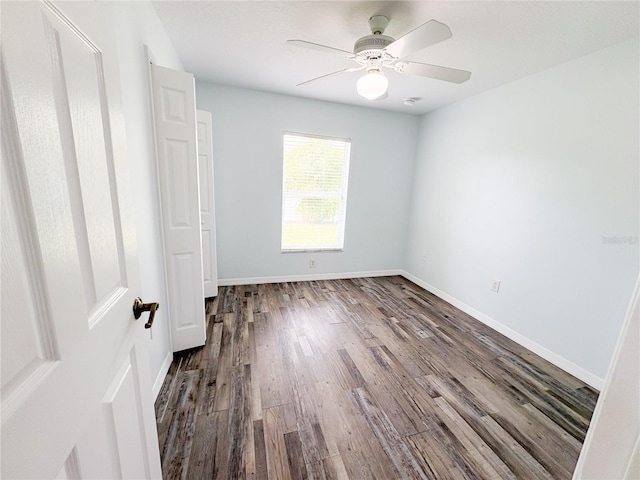 671 E Baffin Dr, Venice, FL 34293 - unfurnished bedroom featuring dark wood-style floors and a ceiling fan