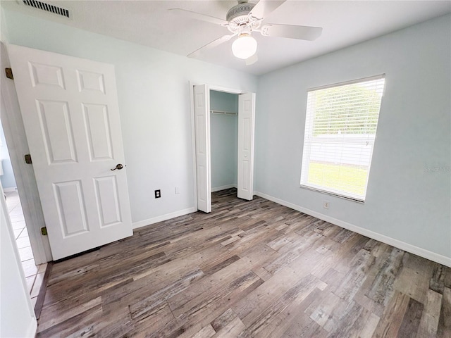 671 E Baffin Dr, Venice, FL 34293 - unfurnished bedroom with wood finished floors, a closet, and ceiling fan