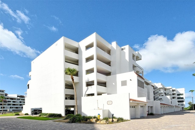 1485 Gulf Of Mexico Dr Unit 101, Longboat Key, FL 34228 - view of property featuring an attached garage and driveway