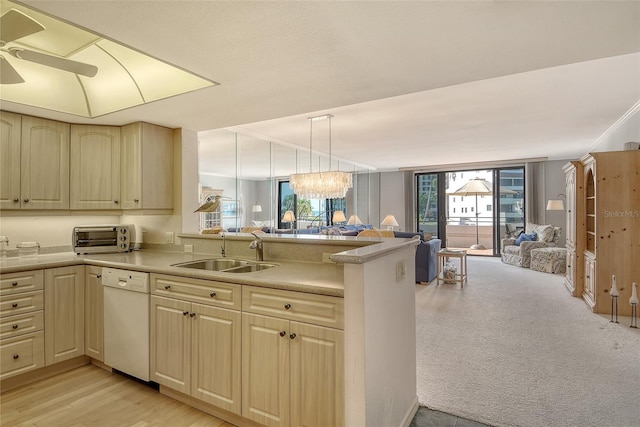 1485 Gulf Of Mexico Dr Unit 101, Longboat Key, FL 34228 - kitchen featuring dishwasher, open floor plan, a peninsula, and light countertops