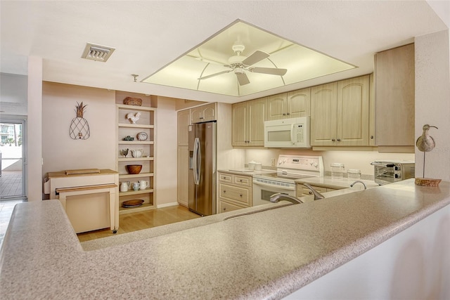 1485 Gulf Of Mexico Dr Unit 101, Longboat Key, FL 34228 - kitchen featuring white appliances, a ceiling fan, light wood-style floors, and light countertops