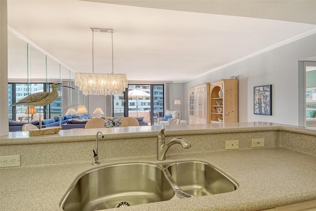 1485 Gulf Of Mexico Dr Unit 101, Longboat Key, FL 34228 - kitchen with open floor plan, a chandelier, crown molding, and hanging light fixtures