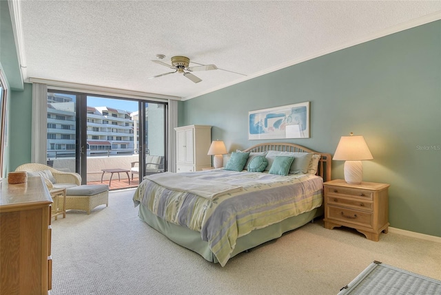 1485 Gulf Of Mexico Dr Unit 101, Longboat Key, FL 34228 - carpeted bedroom featuring access to exterior, a textured ceiling, floor to ceiling windows, crown molding, and a ceiling fan