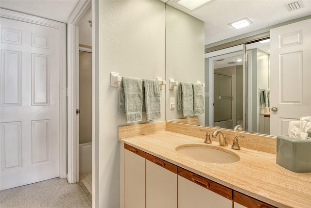 1485 Gulf Of Mexico Dr Unit 101, Longboat Key, FL 34228 - full bathroom with vanity, a closet, and a textured ceiling