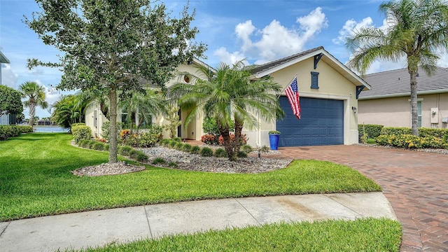 1114 Bearing Ct, Bradenton, FL 34208 - view of front facade featuring an attached garage, stucco siding, decorative driveway, and a front yard