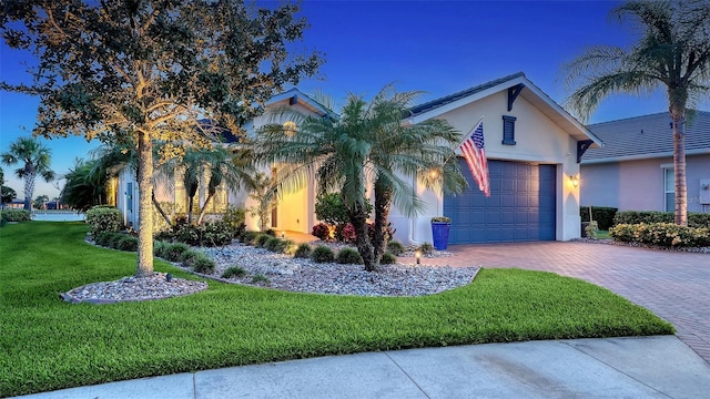 1114 Bearing Ct, Bradenton, FL 34208 - view of front of home featuring a garage, a front yard, decorative driveway, and stucco siding