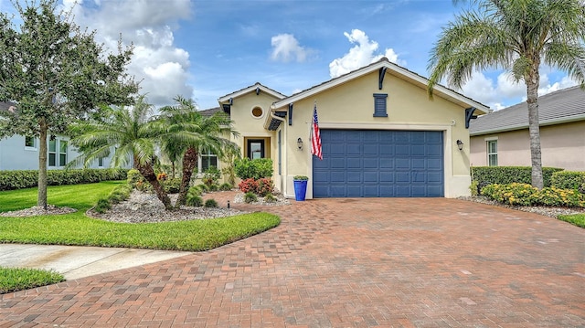 1114 Bearing Ct, Bradenton, FL 34208 - view of front facade featuring stucco siding, an attached garage, decorative driveway, and a front yard