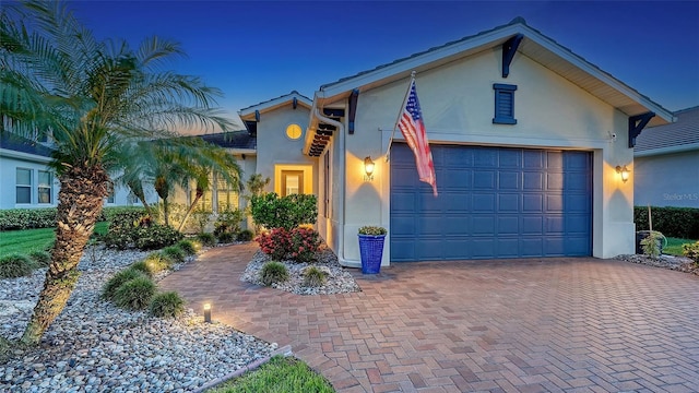 1114 Bearing Ct, Bradenton, FL 34208 - view of front facade with stucco siding, decorative driveway, and an attached garage