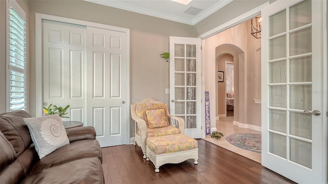 1114 Bearing Ct, Bradenton, FL 34208 - living area with arched walkways, ornamental molding, and dark wood-type flooring