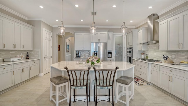 1114 Bearing Ct, Bradenton, FL 34208 - kitchen with wall chimney range hood, stainless steel appliances, decorative backsplash, arched walkways, and recessed lighting
